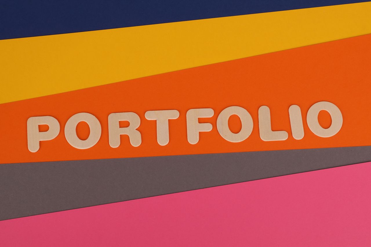 A vibrant multicolored background featuring the text PORTFOLIO in pink font on colorful paper.